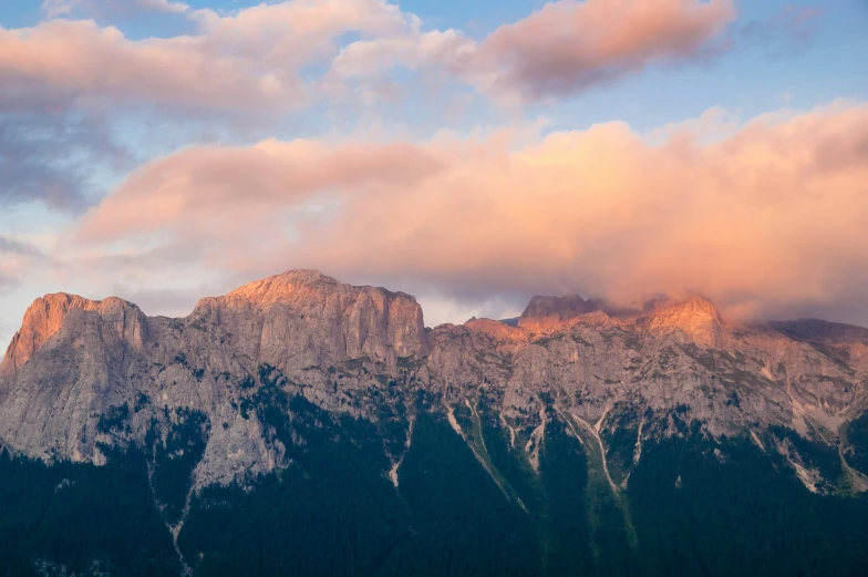 some mountains are in the distance with some clouds