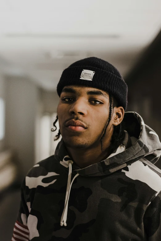 young man wearing a camouflage jacket and hat