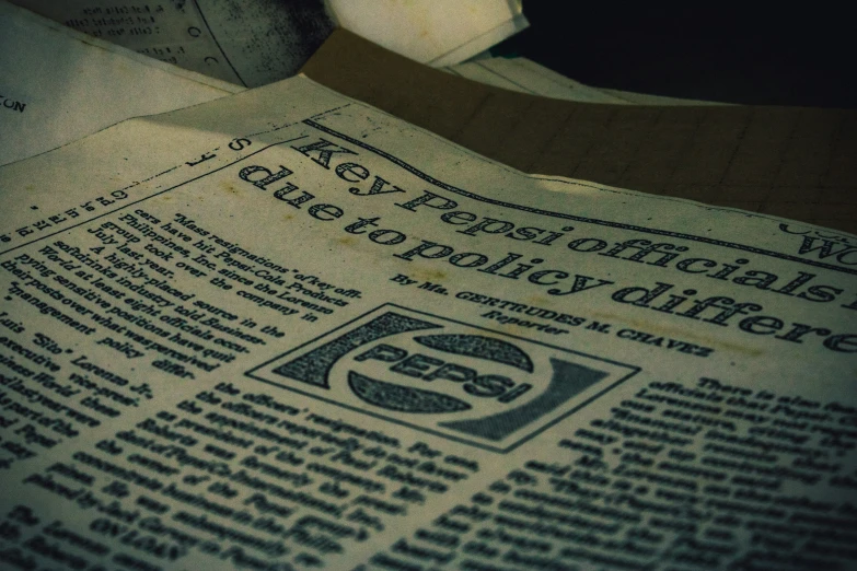the news paper is folded up next to a banana