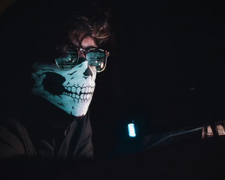 a person with a skeleton face on at night