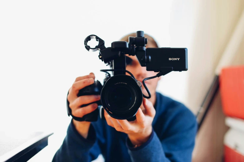 a person holding a camera taking a picture with it