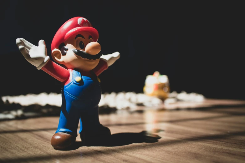 toy mario running on the floor with his arms extended