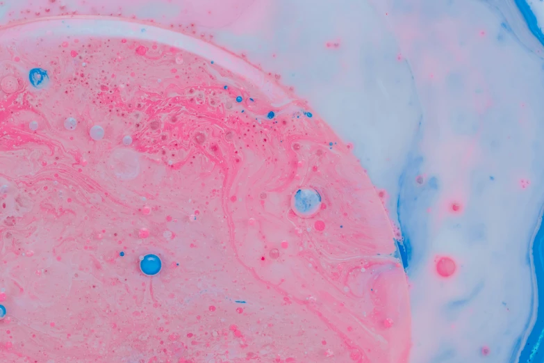 a pink and blue substance in a liquid filled bowl
