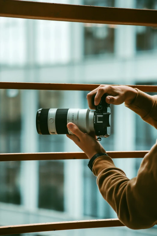 a woman taking a picture through a window using a camera