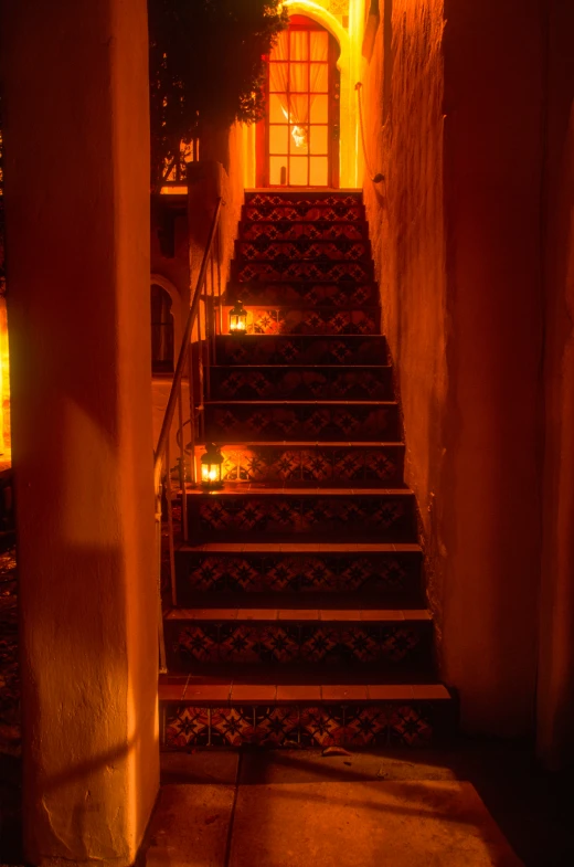 an entrance leads to stairs that lead up to a lit window