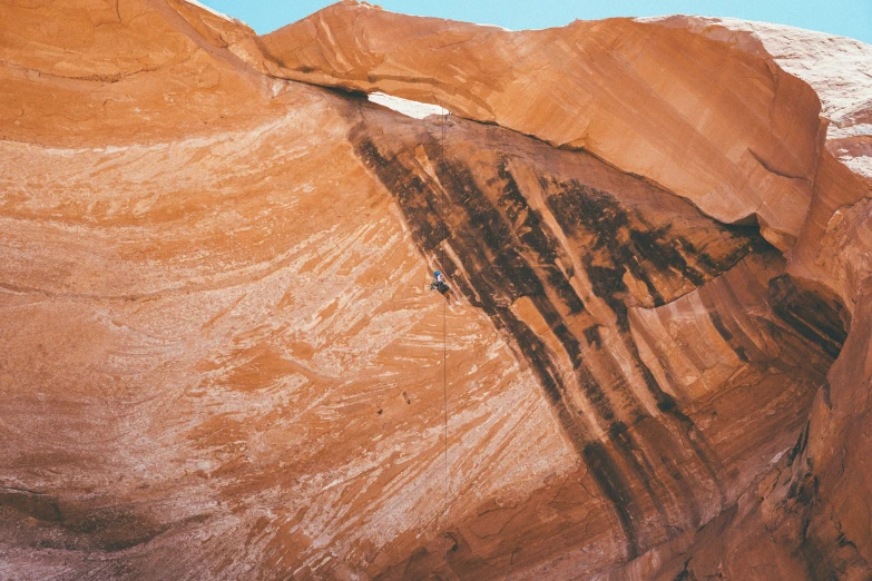 an image of a rock formation with a mountain in the background