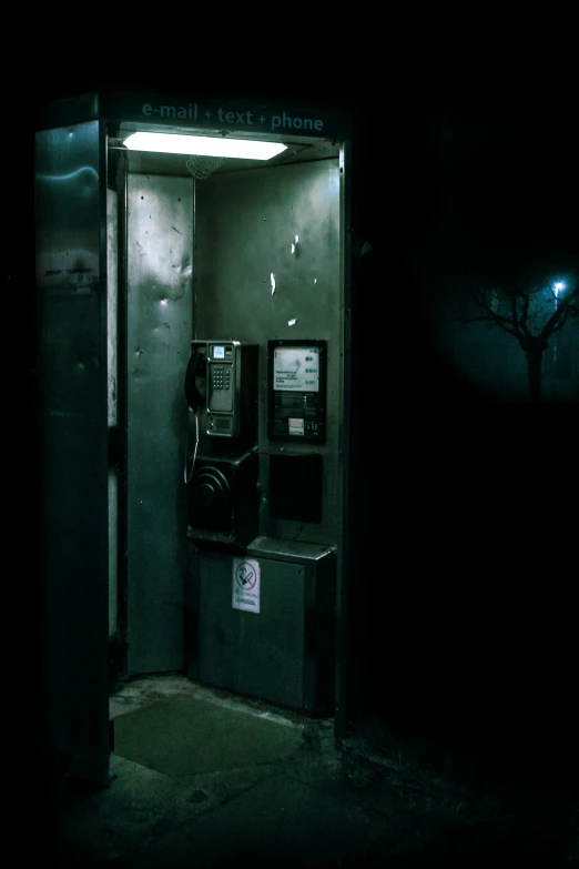 a cell phone sitting in the corner of a dark room