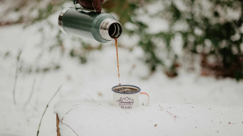 a person holding a coffee cup filled with liquid