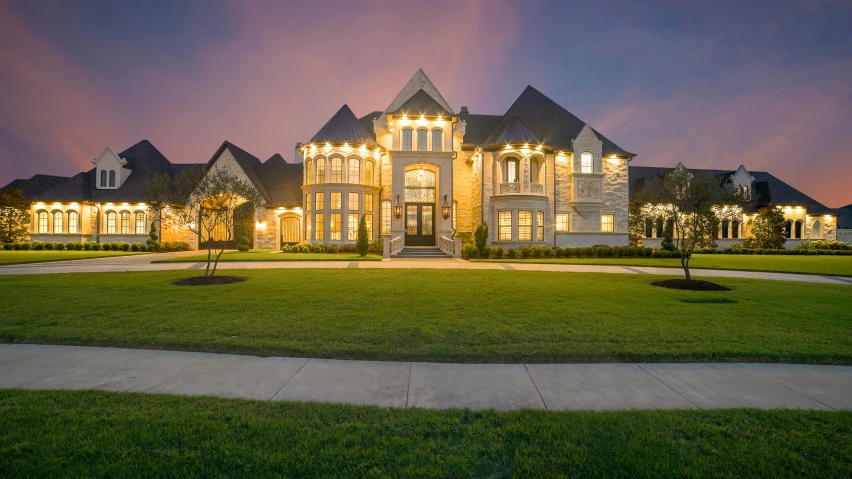 a home lit up in the night, at dusk