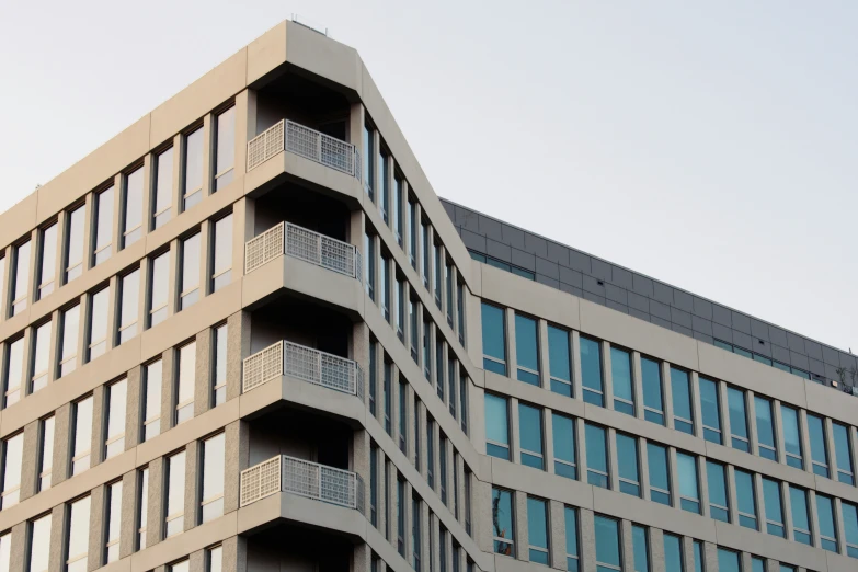 an office building with balconies on the second floor