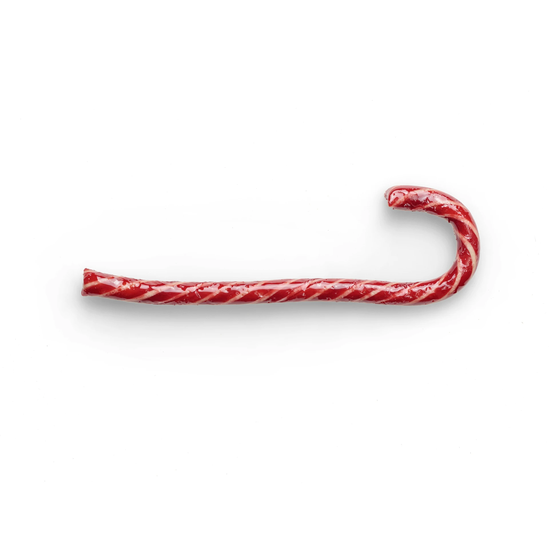 a candy cane with some light brown colored stuff hanging off the end