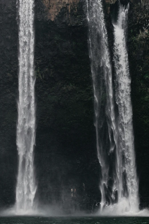 there are two tall waterfalls sticking out of the water