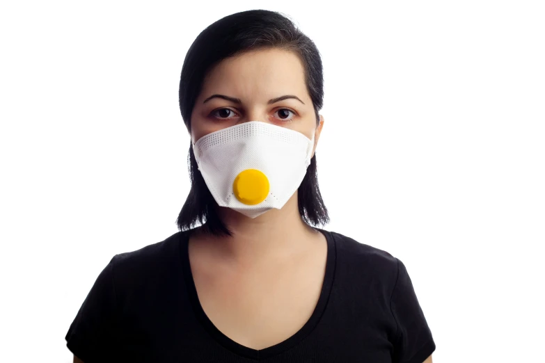 a woman wears a mask that is made of cotton fabric and features an egg on the front