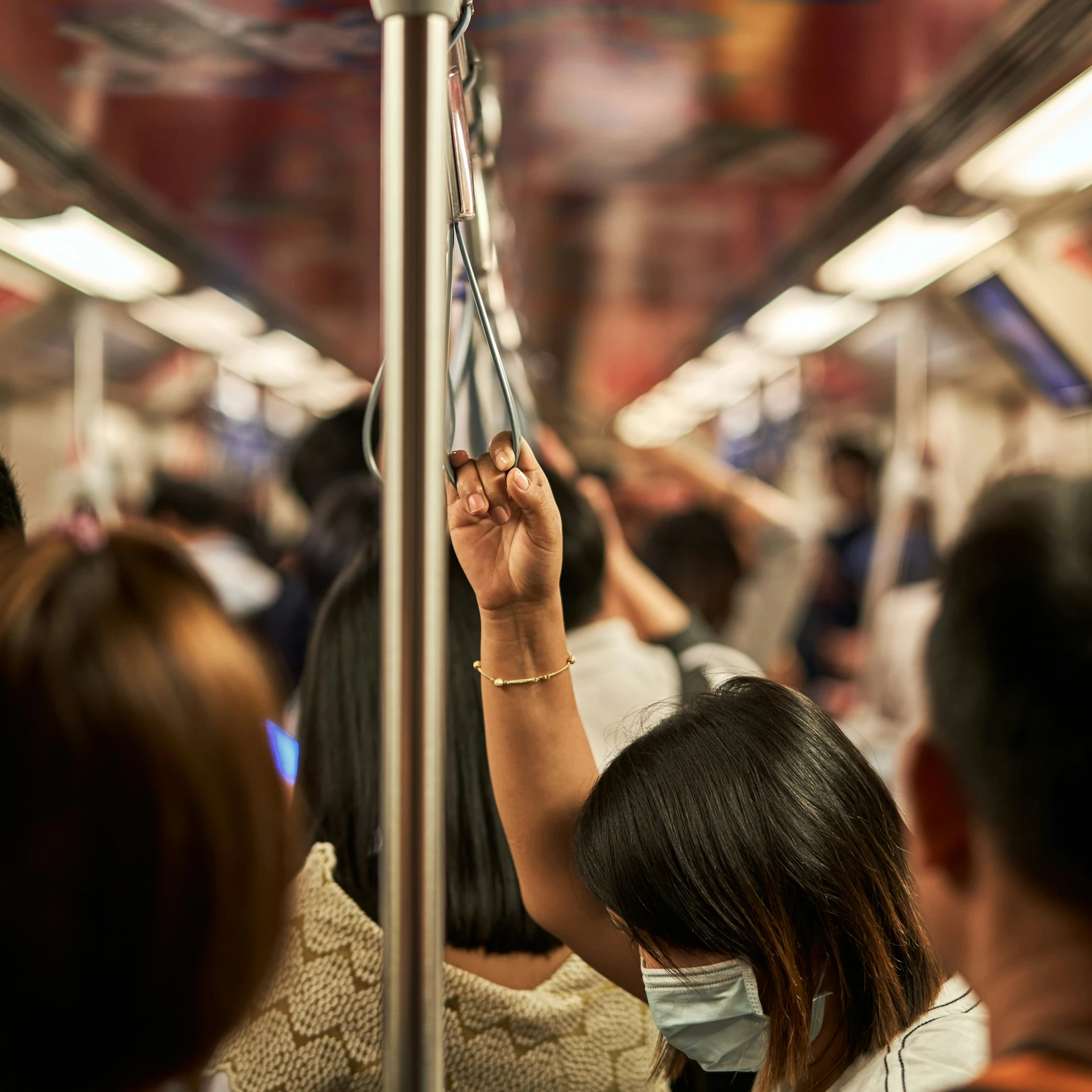 a woman is seen wearing a surgical face mask on a train