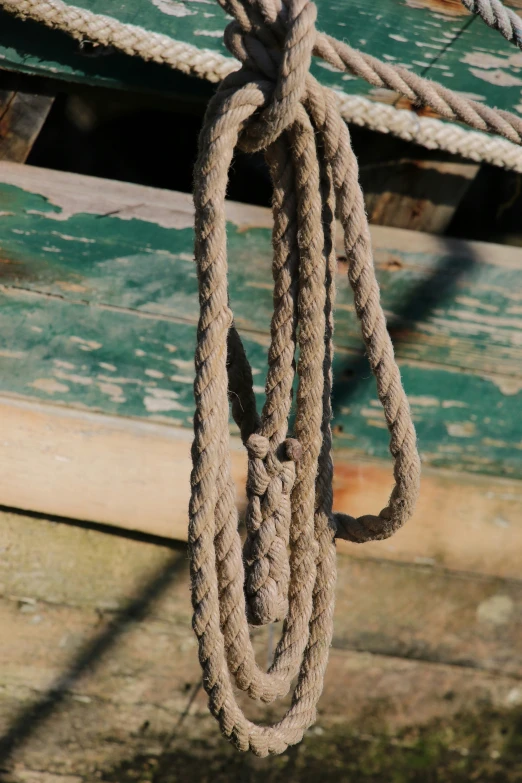 a rope is tied to a boat on the beach