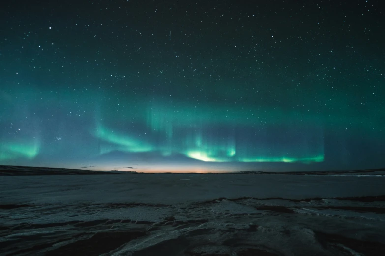 the night sky with stars and bright green lights