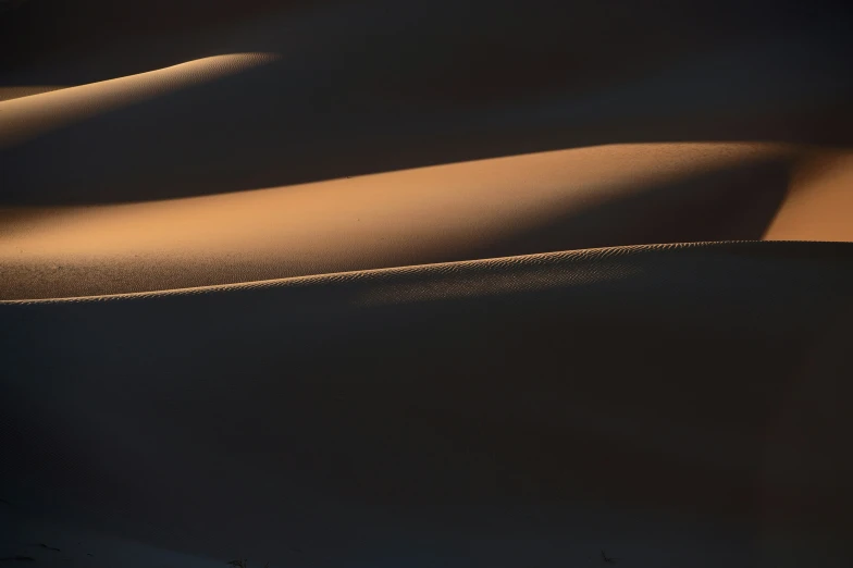 some brown sand dunes near one another