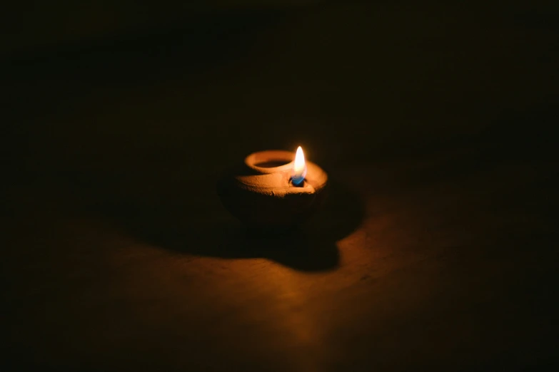 a small candle that is glowing on a table