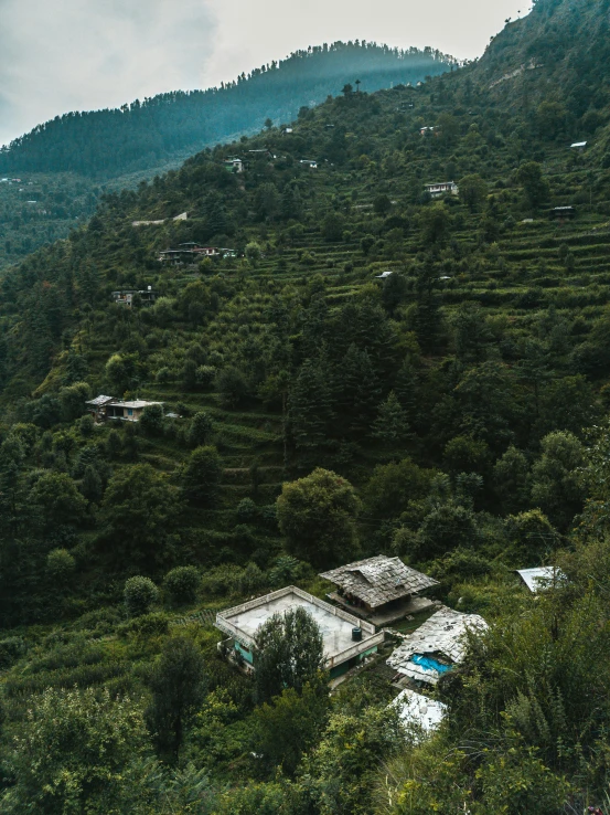 an aerial view of a hilly area with a pool