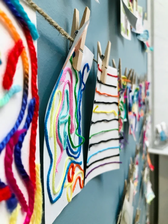 colorful clothes hanging on clothes pins and cloth