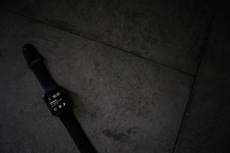 a closeup of a watch resting on the ground