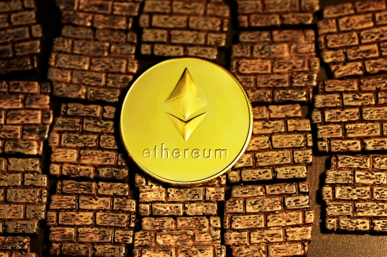 a gold object sits on bricks in front of the word'ether '