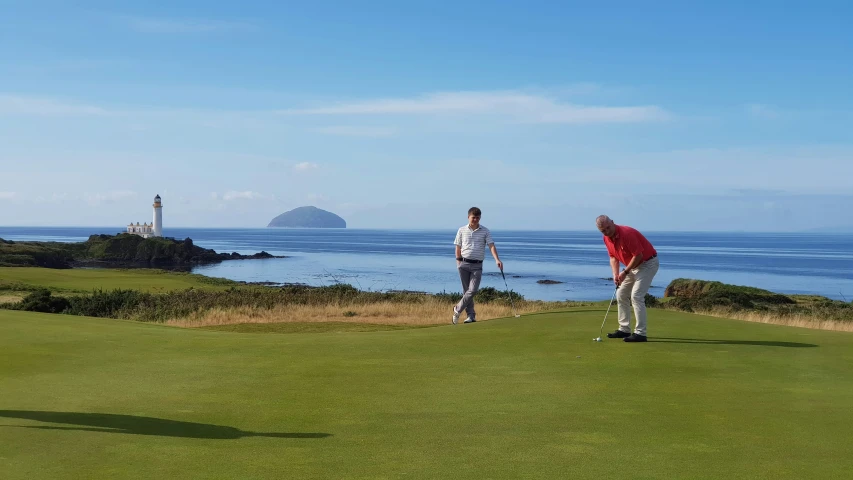 a golf player standing on the edge of the golf course