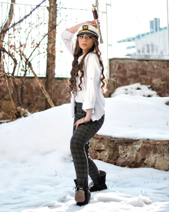 a pretty  standing in the snow wearing sailor attire