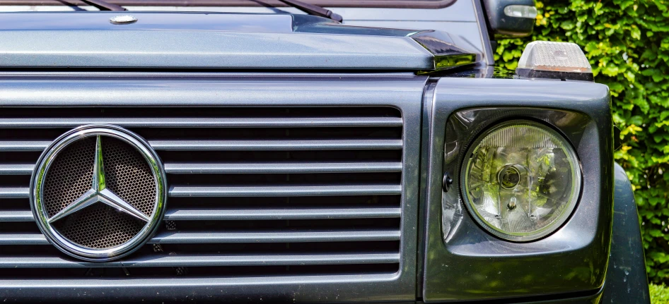an old mercedes is shown with the headlight on
