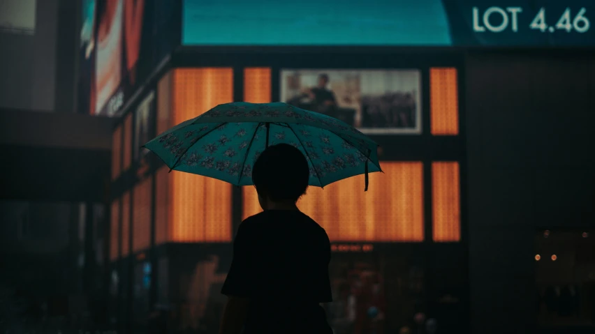 a man holding a white umbrella in the street