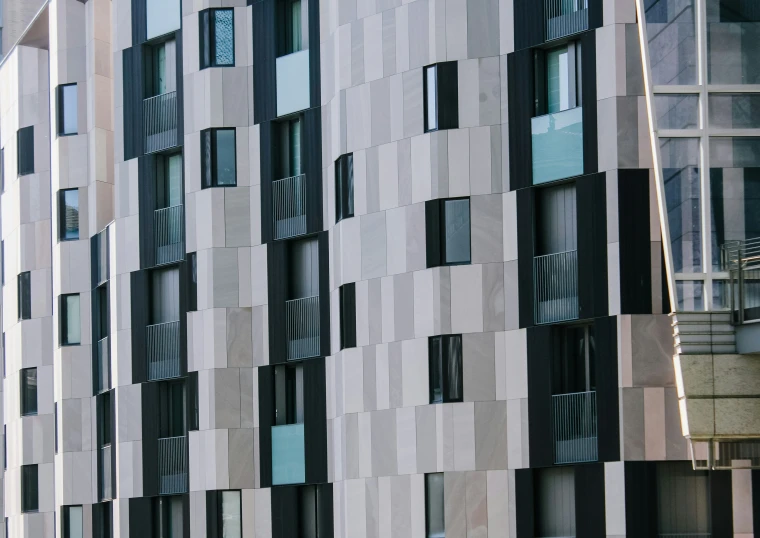 a black and white building next to a wall