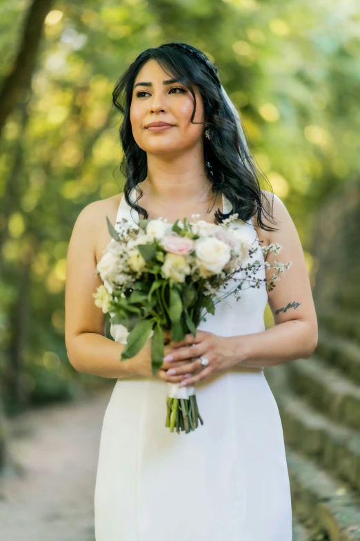 a bride with flowers in her bouquet holding a bouquet