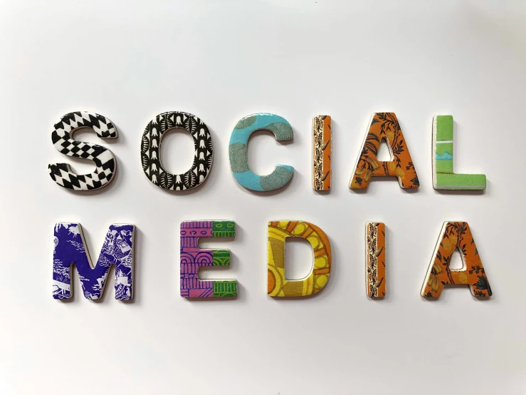 the words social media are made up of colorful paper letters