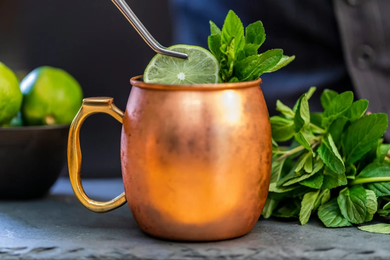 a close up of a gold cup filled with drinks