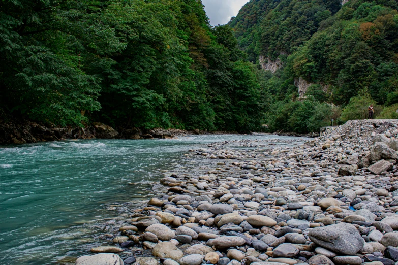 river in mountains with rocks and water running underneath