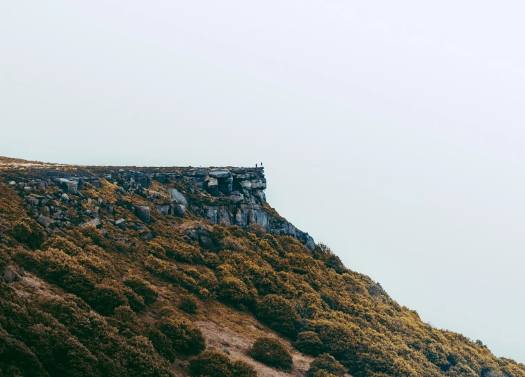 a hill that has some grass on it