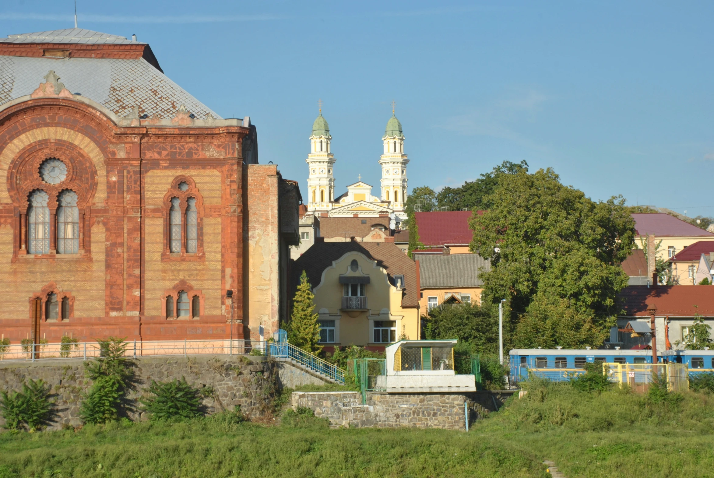 there is a building near the water and a small train