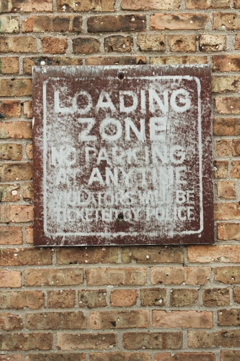 a loading zone on a brick wall that is not painted