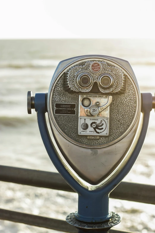 a closeup view of a parking meter overlooking water