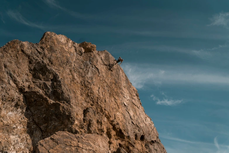 a mountain climber high up on a rock face