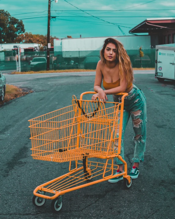 a girl squatting down in front of a shopping cart
