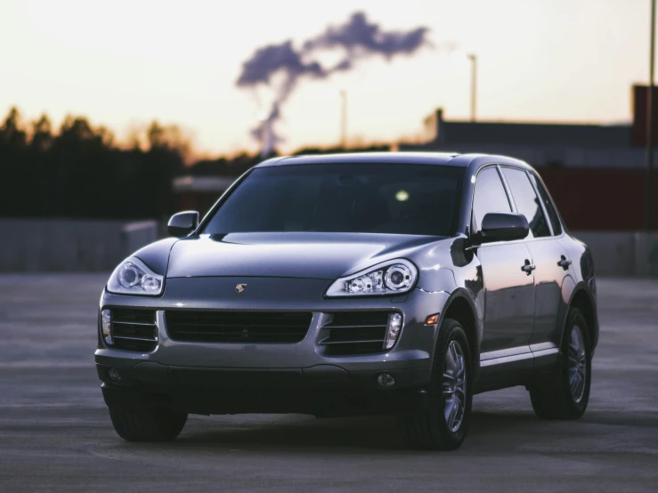 a silver car parked on an empty lot