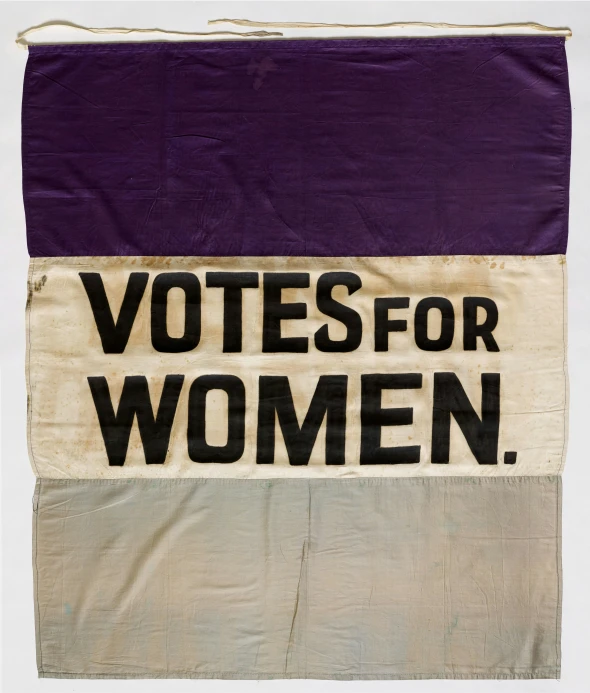 a piece of purple, brown and tan cloth that reads vote for women