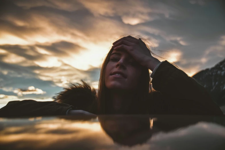 a person standing next to a body of water