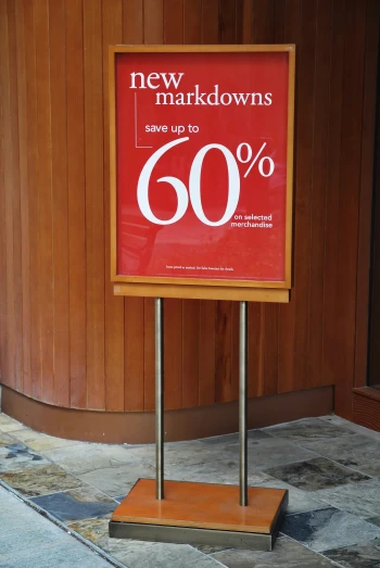 a red sign advertising new make downs save up to 60 %