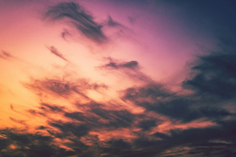 a plane is seen flying through a colorful sky