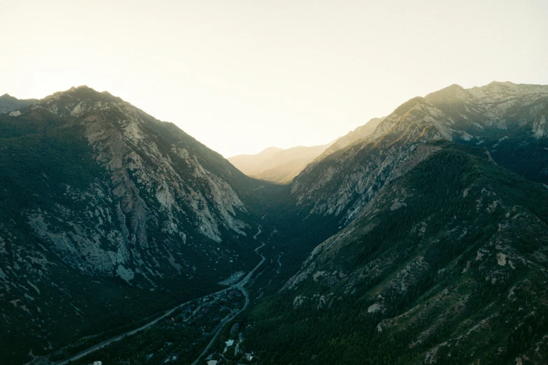 some mountains are in the background while a sun is setting