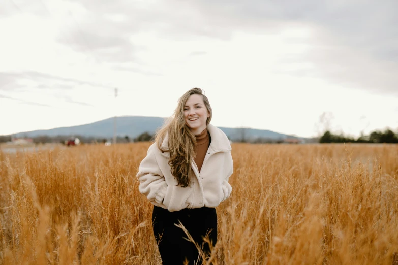 a woman with long hair in a field