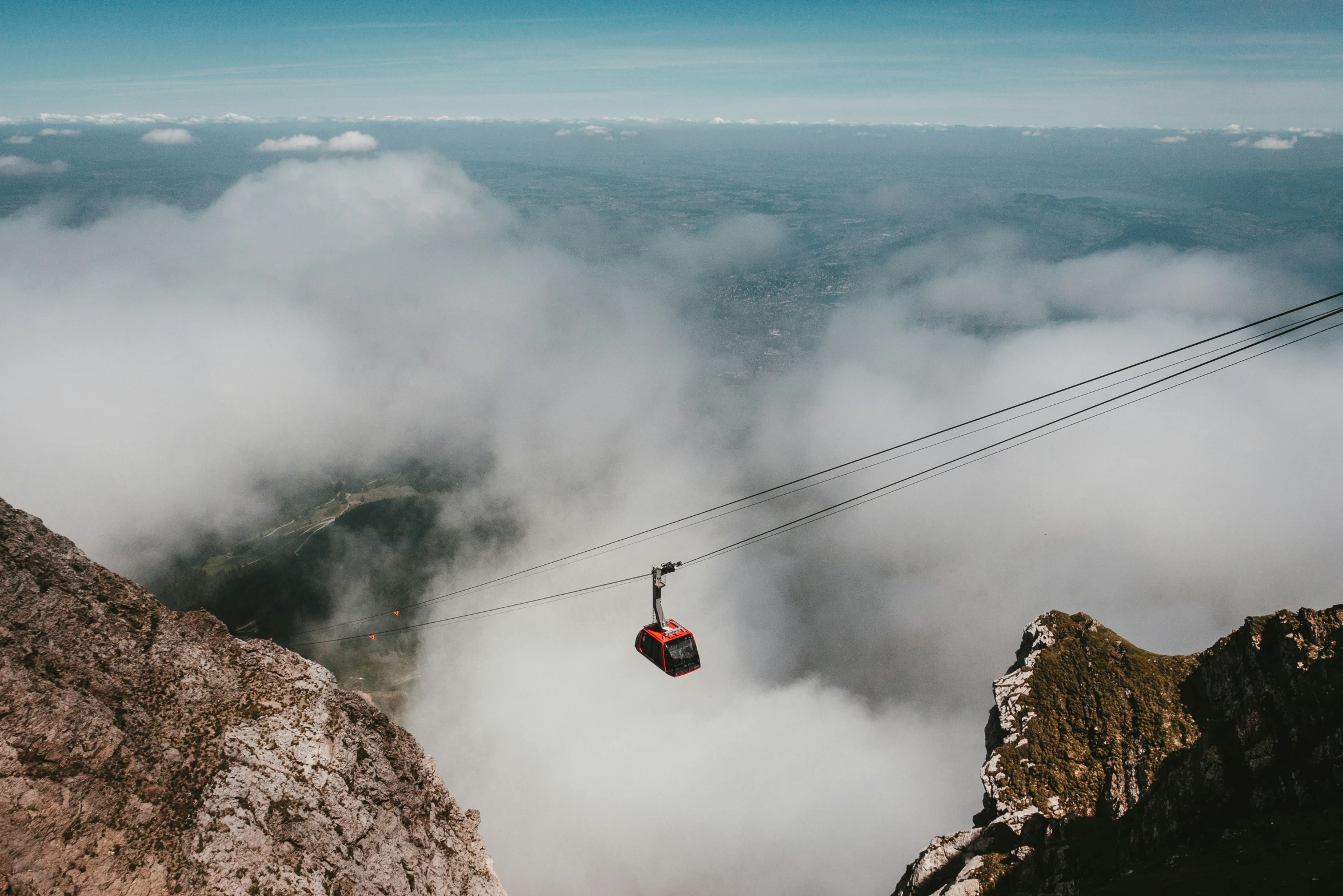 a chair lift over a foggy mountain area