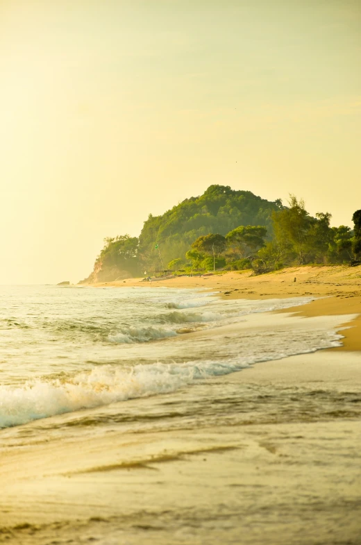 a lone beach with waves and sand on the shore